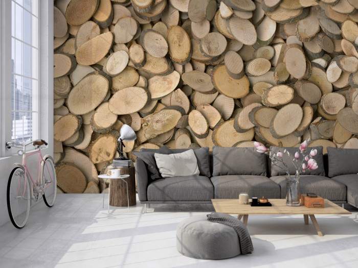 Die Fototapete Holzscheiben von Ästen auf einer großen Wand im Loft tapeziert. Die Fototapete Holzscheiben von Ästen wird individuell auf Deine Wand angepasst.