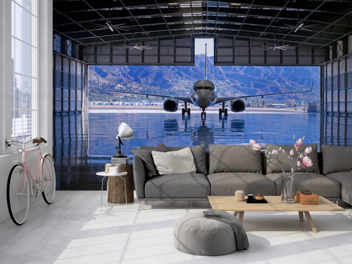 Die Fototapete Flugzeug im Hangar auf einer großen Wand im Loft tapeziert. Die Fototapete Flugzeug im Hangar wird individuell auf Deine Wand angepasst.