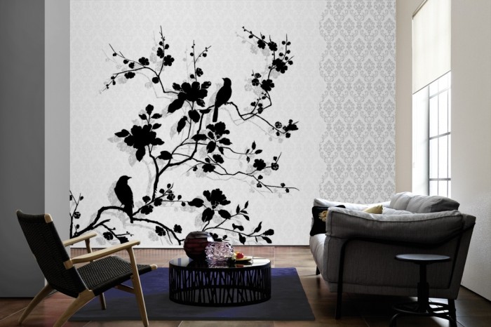 Im Wohnzimmer die Design-Fototapete Vögel in Schwarz, Artwork auf einer großen Wand tapeziert. Die Design-Fototapete Vögel in Schwarz, Artwork ist als Vlies-Fototapete im Wohnzimmer leicht zu tapezieren.
