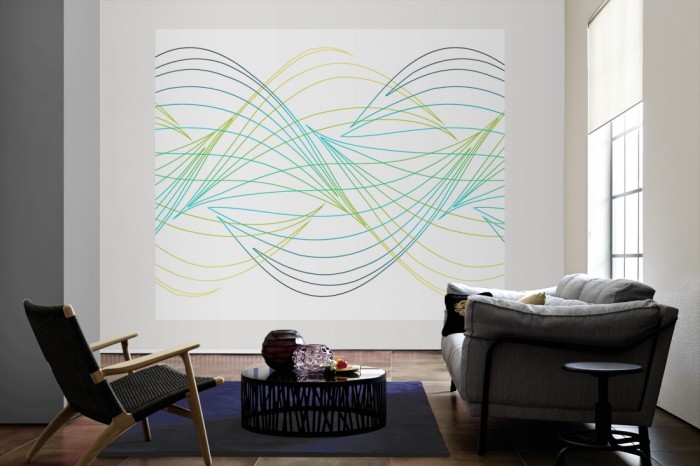 Die Design-Fototapete Geometrie Wellen in Grün als große Bildtapete im Wohnzimmer. Als Bildtapete ist die Design-Fototapete Geometrie Wellen in Grün ein besonderes Highlight auf Vliestapete.