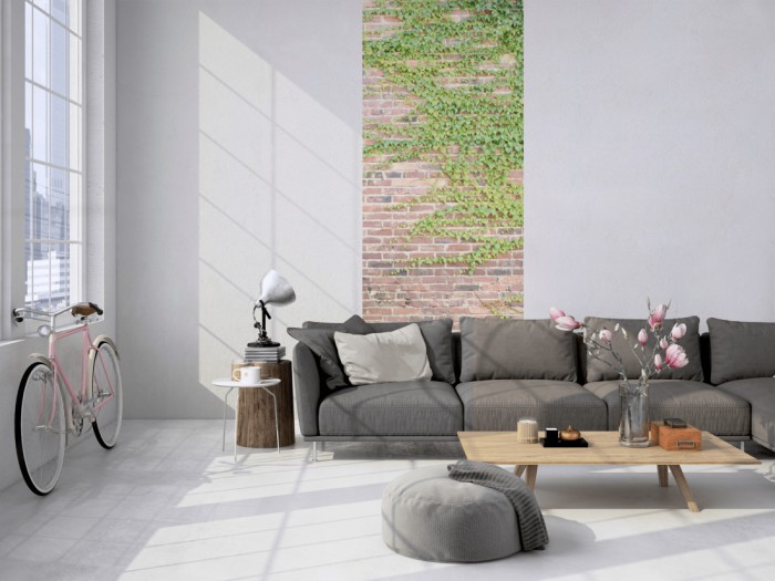 Das 3D-Fotopanel Ziegel Steinwand mit Efeu tapeziert in einem Loft. Bestelle die Bildtapete für Deine Wand online.