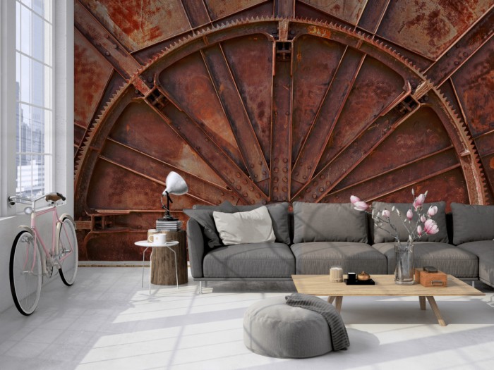 Die Fototapete Altes Maschinenrad, Industrie auf einer großen Wand im Loft tapeziert. Die Fototapete Altes Maschinenrad, Industrie wird individuell auf Deine Wand angepasst.