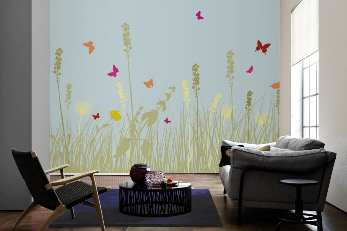 Im Wohnzimmer die Design-Fototapete Blumenwiese Sommer, Artwork auf einer großen Wand tapeziert. Die Design-Fototapete Blumenwiese Sommer, Artwork ist als Vlies-Fototapete im Wohnzimmer leicht zu tapezieren.