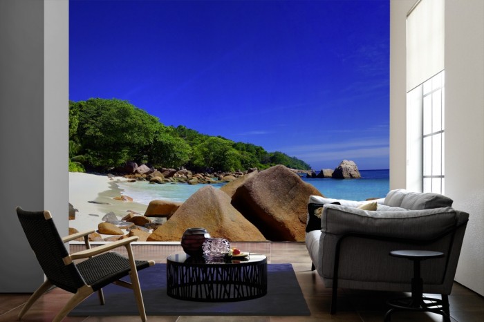 Im Wohnzimmer die Fototapete Strand der Seychellen auf einer großen Wand tapeziert. Die Fototapete Strand der Seychellen ist als Vlies-Fototapete im Wohnzimmer leicht zu tapezieren.