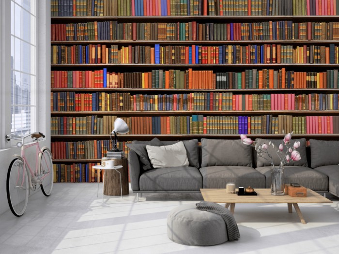 Die Fototapete Bücherregal einer Bibliothek auf einer großen Wand im Loft tapeziert. Die Fototapete Bücherregal einer Bibliothek wird individuell auf Deine Wand angepasst.