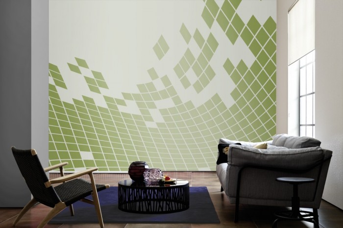 Im Wohnzimmer die Design-Fototapete 3D-Geometrie in grün-weiß auf einer großen Wand tapeziert. Die Design-Fototapete 3D-Geometrie in grün-weiß ist als Vlies-Fototapete im Wohnzimmer leicht zu tapezieren.