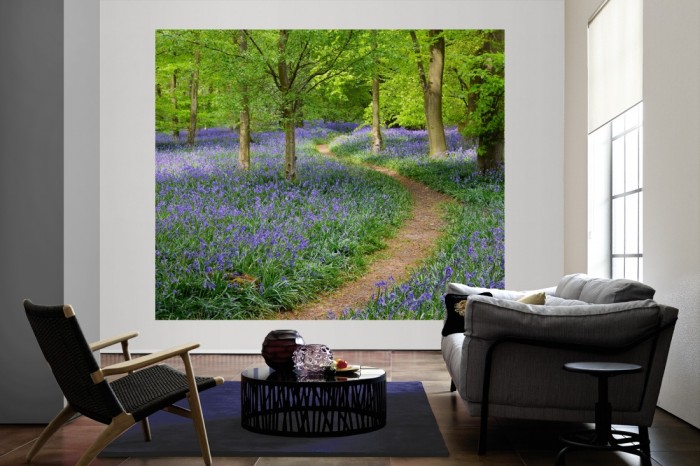 Die Fototapete Waldweg mit Blumen im Sommer als große Bildtapete im Wohnzimmer. Als Bildtapete ist die Fototapete Waldweg mit Blumen im Sommer ein besonderes Highlight auf Vliestapete.