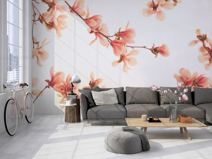 Die Fototapete Magnolie Äste in Rosa auf einer großen Wand im Loft tapeziert. Die Fototapete Magnolie Äste in Rosa wird individuell auf Deine Wand angepasst.