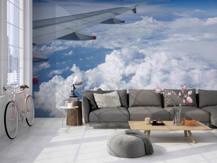 Die Fototapete Über den Wolken 2 auf einer großen Wand im Loft tapeziert. Die Fototapete Über den Wolken 2 wird individuell auf Deine Wand angepasst.