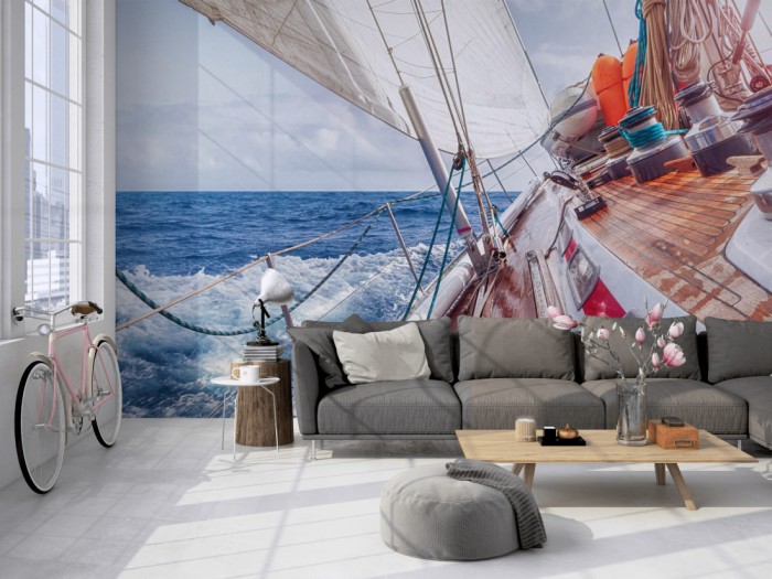 Die Fototapete Segelboot im Meer auf einer großen Wand im Loft tapeziert. Die Fototapete Segelboot im Meer wird individuell auf Deine Wand angepasst.
