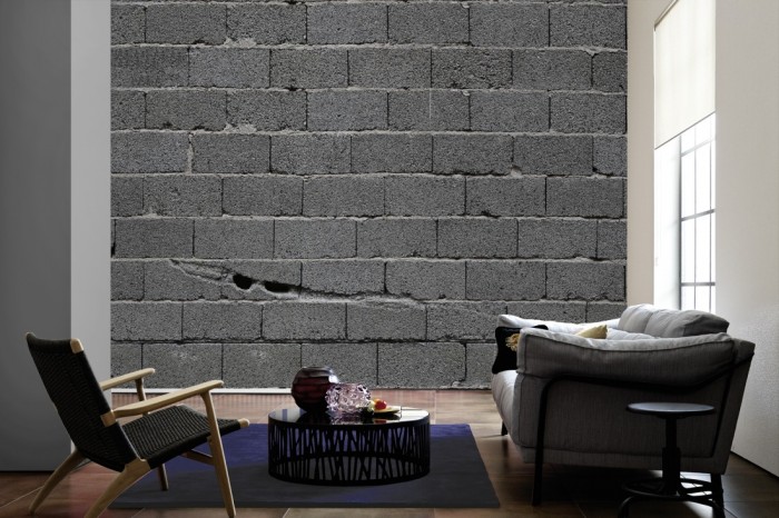 Im Wohnzimmer die Fototapete Stein Wand, Rohbau Steine auf einer großen Wand tapeziert. Die Fototapete Stein Wand, Rohbau Steine ist als Vlies-Fototapete im Wohnzimmer leicht zu tapezieren.