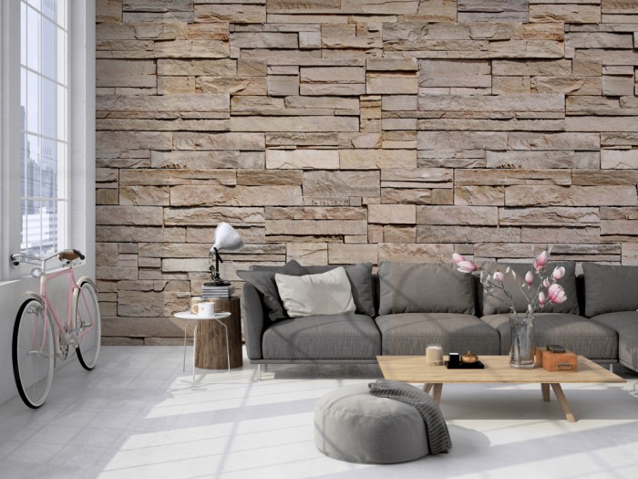 Die Fototapete Stein Wand, Naturstein beige-grau auf einer großen Wand im Loft tapeziert. Die Fototapete Stein Wand, Naturstein beige-grau wird individuell auf Deine Wand angepasst.