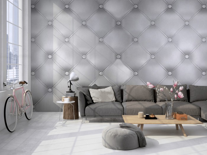 Die Design-Fototapete 3D-Effekt mit grauem Polster auf einer großen Wand im Loft tapeziert. Die Design-Fototapete 3D-Effekt mit grauem Polster wird individuell auf Deine Wand angepasst.