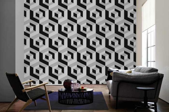 Im Wohnzimmer die Design-Fototapete 3D-Geometrie Würfel in Grau auf einer großen Wand tapeziert. Die Design-Fototapete 3D-Geometrie Würfel in Grau ist als Vlies-Fototapete im Wohnzimmer leicht zu tapezieren.