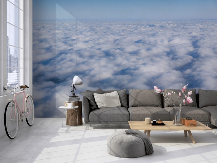 Die Fototapete Über den Wolken 1 auf einer großen Wand im Loft tapeziert. Die Fototapete Über den Wolken 1 wird individuell auf Deine Wand angepasst.