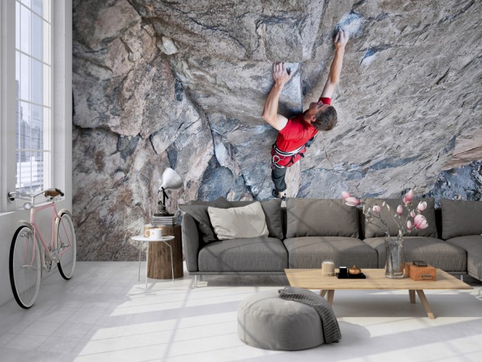 Die Fototapete Felswand mit Bergsteiger auf einer großen Wand im Loft tapeziert. Die Fototapete Felswand mit Bergsteiger wird individuell auf Deine Wand angepasst.