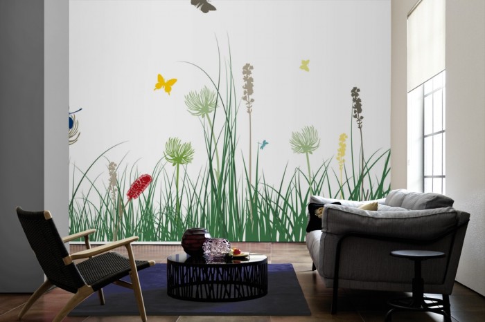 Im Wohnzimmer die Design-Fototapete Blumenwiese Frühling, Artwork auf einer großen Wand tapeziert. Die Design-Fototapete Blumenwiese Frühling, Artwork ist als Vlies-Fototapete im Wohnzimmer leicht zu tapezieren.