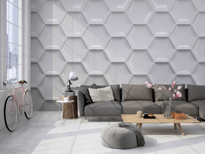 Die Design-Fototapete 3D-Effekt mit grauen Waben auf einer großen Wand im Loft tapeziert. Die Design-Fototapete 3D-Effekt mit grauen Waben wird individuell auf Deine Wand angepasst.