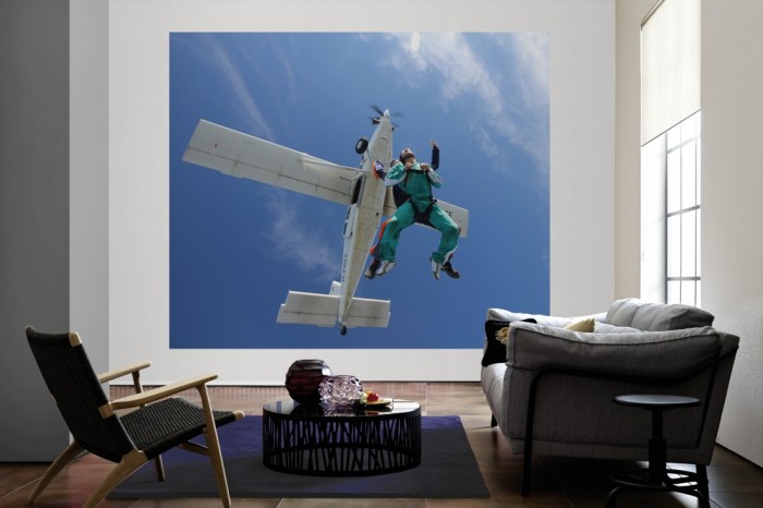 Die Fototapete Fallschirmsprung als große Bildtapete im Wohnzimmer. Als Bildtapete ist die Fototapete Fallschirmsprung ein besonderes Highlight auf Vliestapete.