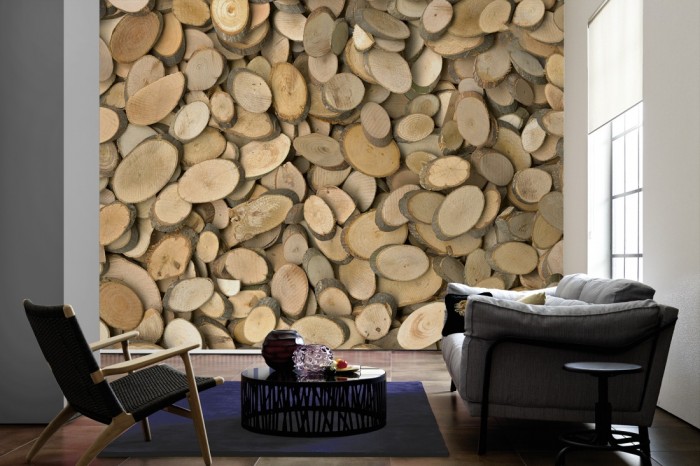 Im Wohnzimmer die Fototapete Holzscheiben von Ästen auf einer großen Wand tapeziert. Die Fototapete Holzscheiben von Ästen ist als Vlies-Fototapete im Wohnzimmer leicht zu tapezieren.